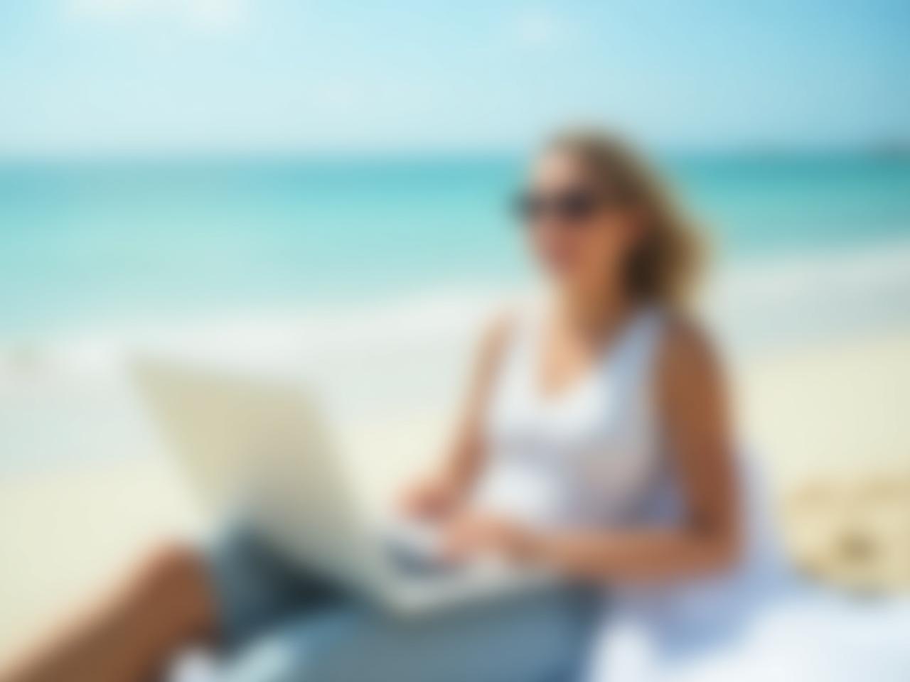 Image of a happy person relaxing on a beach with a laptop, symbolizing financial freedom achieved through automated savings and investments. Keywords: financial freedom, automated investing, passive income, beach, laptop, success.