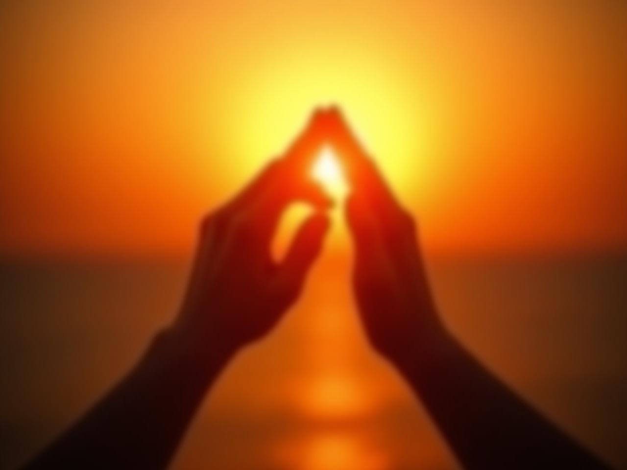 Hands clasped in gratitude under a warm, inviting sunset, symbolizing appreciation and the path to happiness.
